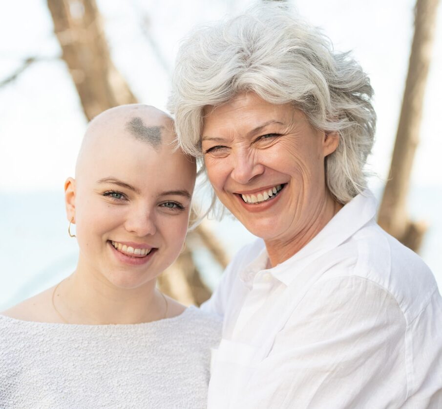 Young woman with cancer embracing her mother